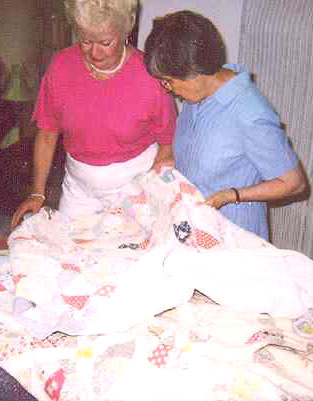 Sewist repairing quilts in the atelier