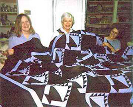 Sewist repairing quilts in the atelier