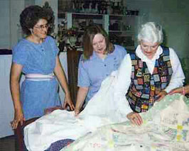 Sewist repairing quilts in the atelier